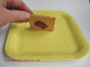 Stick cracker to the plate with a blob of edible glue