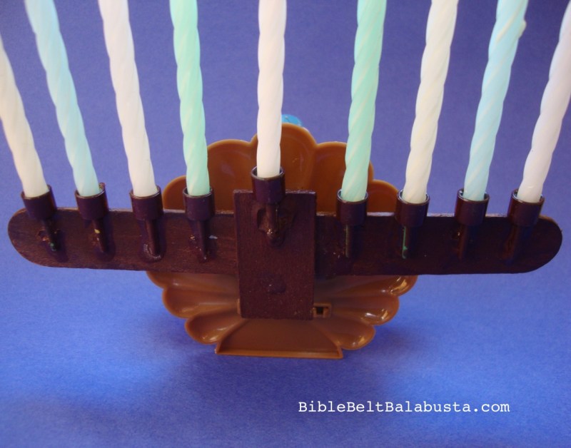 back view of solar-powered turkey toy as menorah